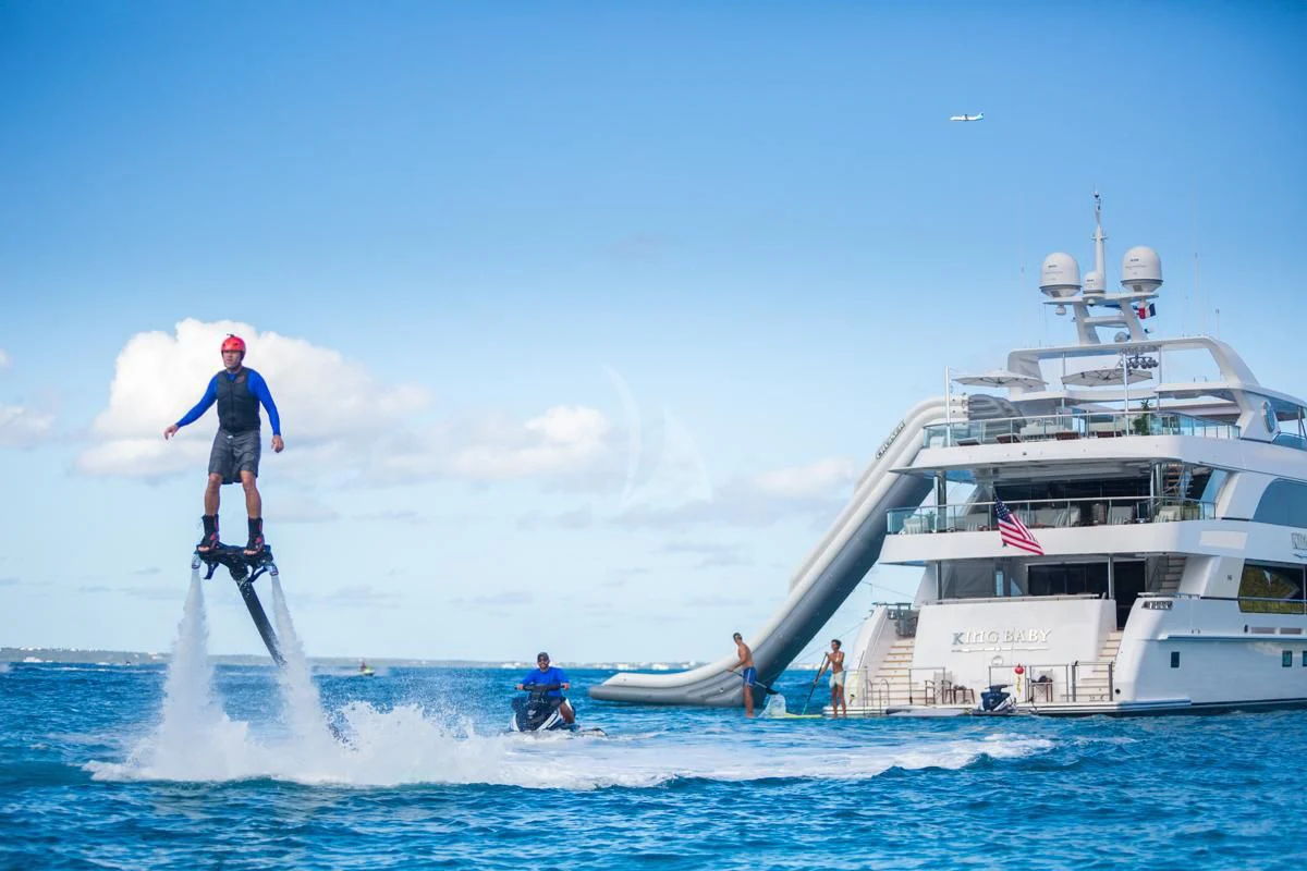 a man jumping off a boat aboard KING BABY Yacht for Sale