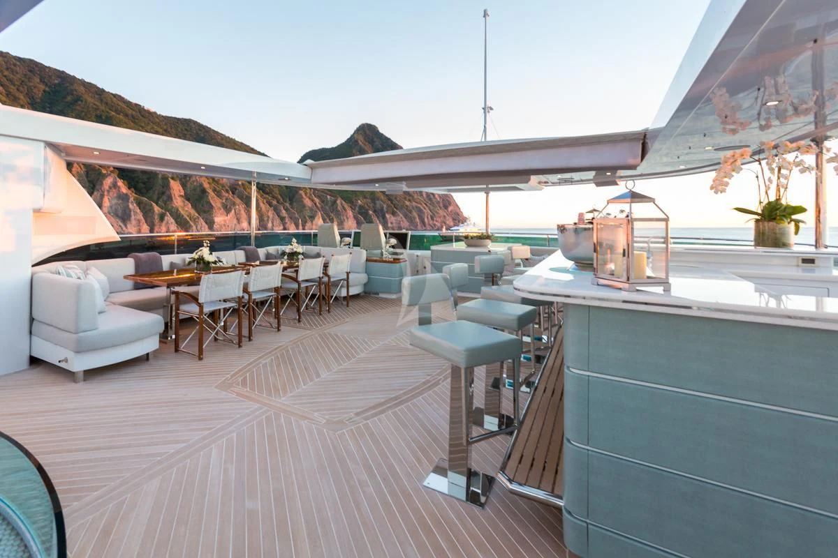 a patio with a bar and a pool aboard KING BABY Yacht for Sale