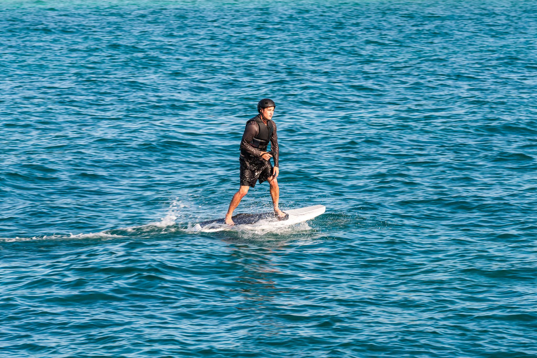 a man surfing on the sea aboard KING BABY Yacht for Sale