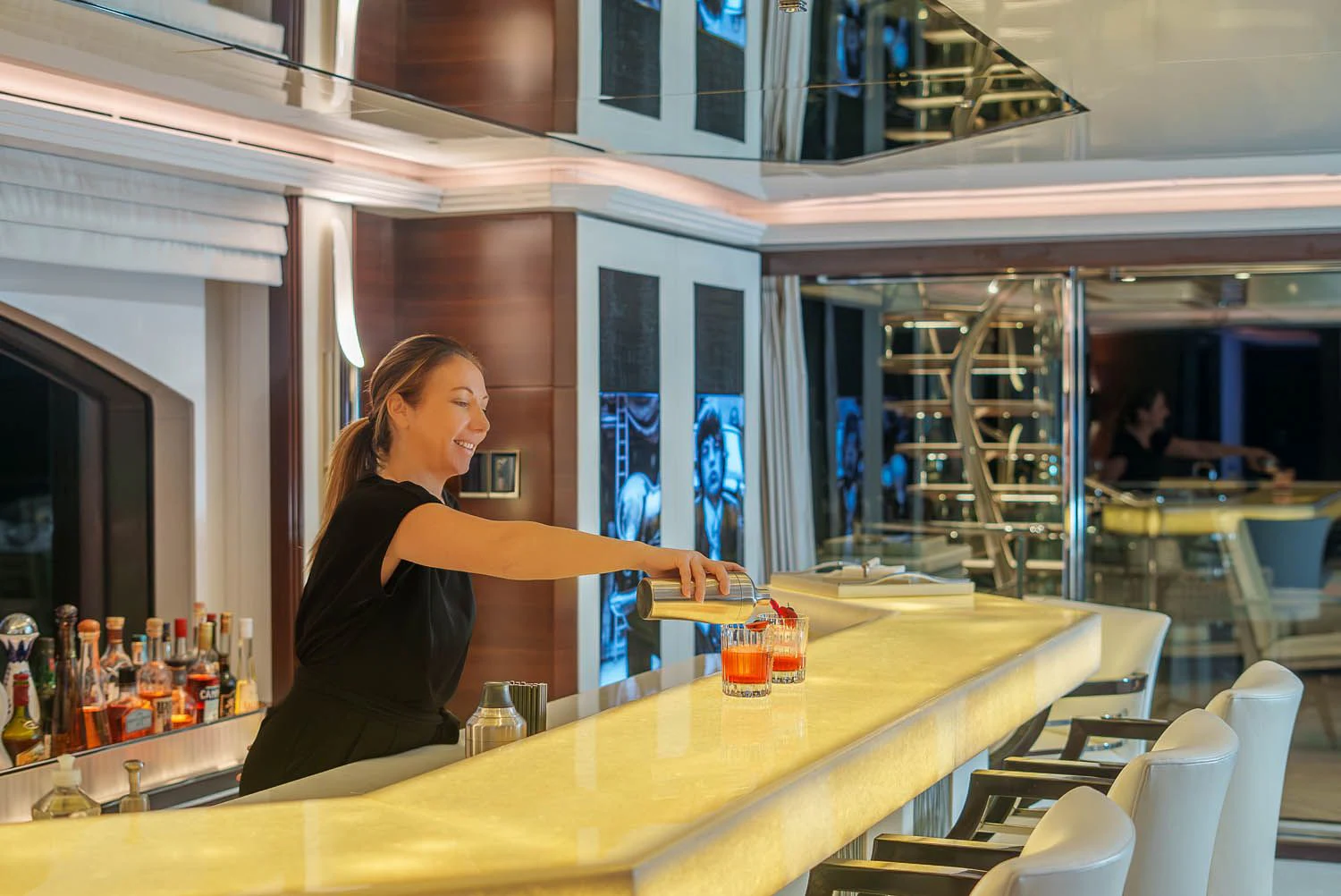a person standing at a bar aboard KING BABY Yacht for Sale