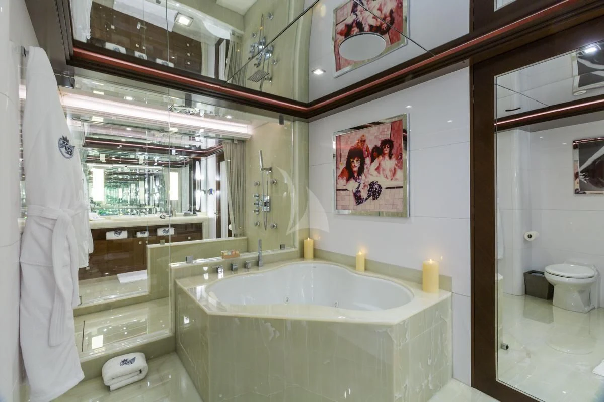 a bathroom with a tub sink and toilet aboard KING BABY Yacht for Sale