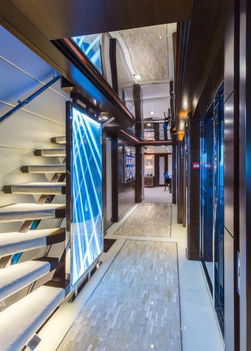 a long hallway with blue doors aboard KING BABY Yacht for Sale