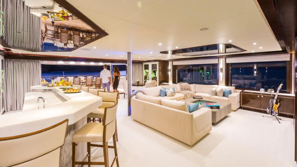 a living room with a couch and a kitchen aboard KING BABY Yacht for Sale