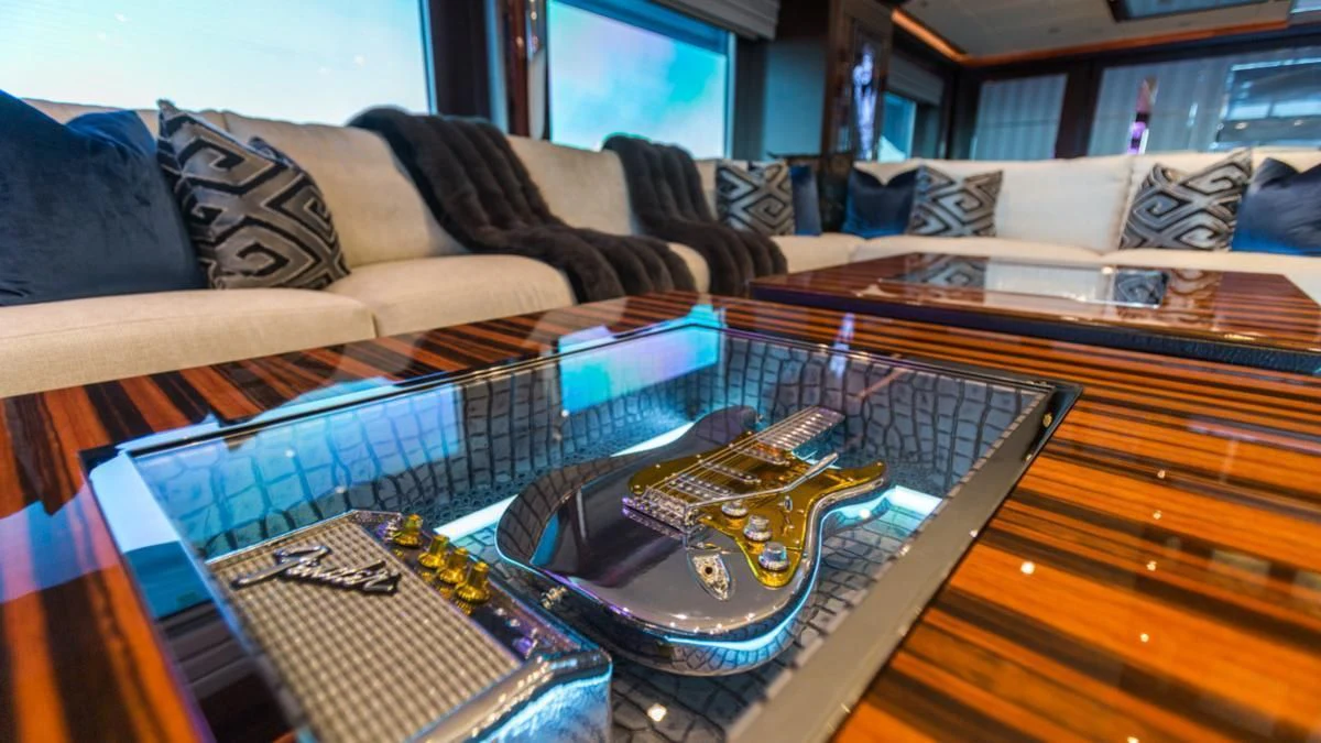 a guitar on a couch aboard KING BABY Yacht for Sale