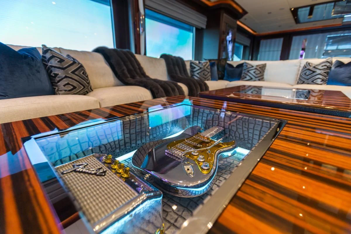 a guitar on a couch aboard KING BABY Yacht for Sale