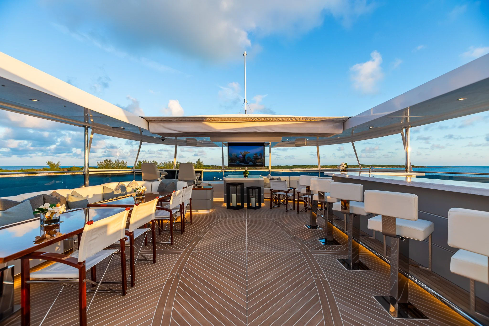 a large patio with tables and chairs aboard KING BABY Yacht for Sale