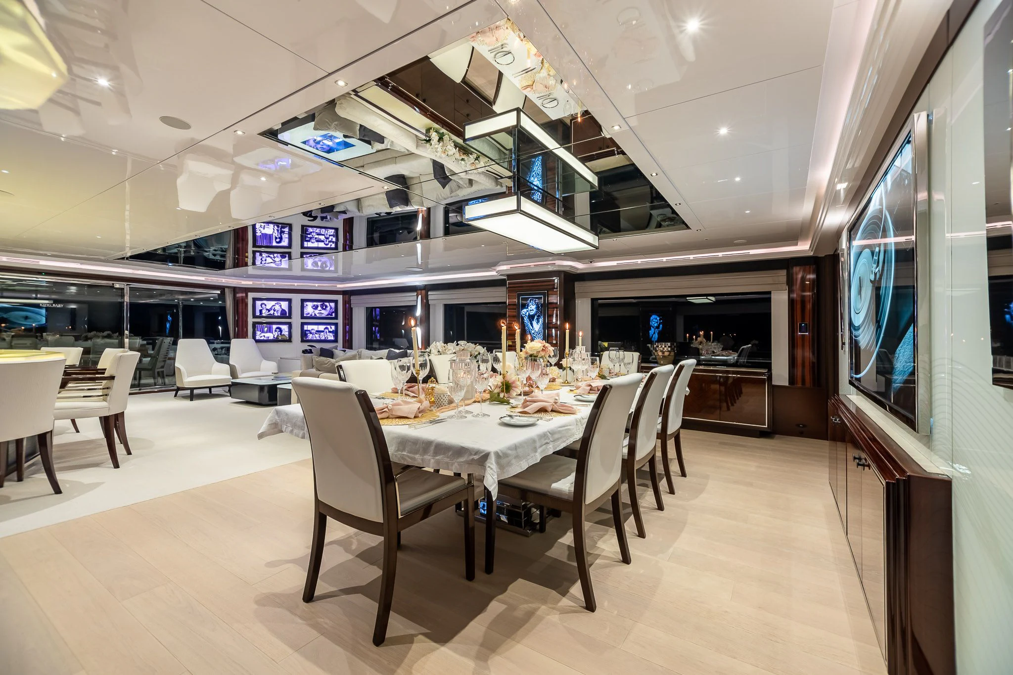 a large room with tables and chairs aboard KING BABY Yacht for Sale