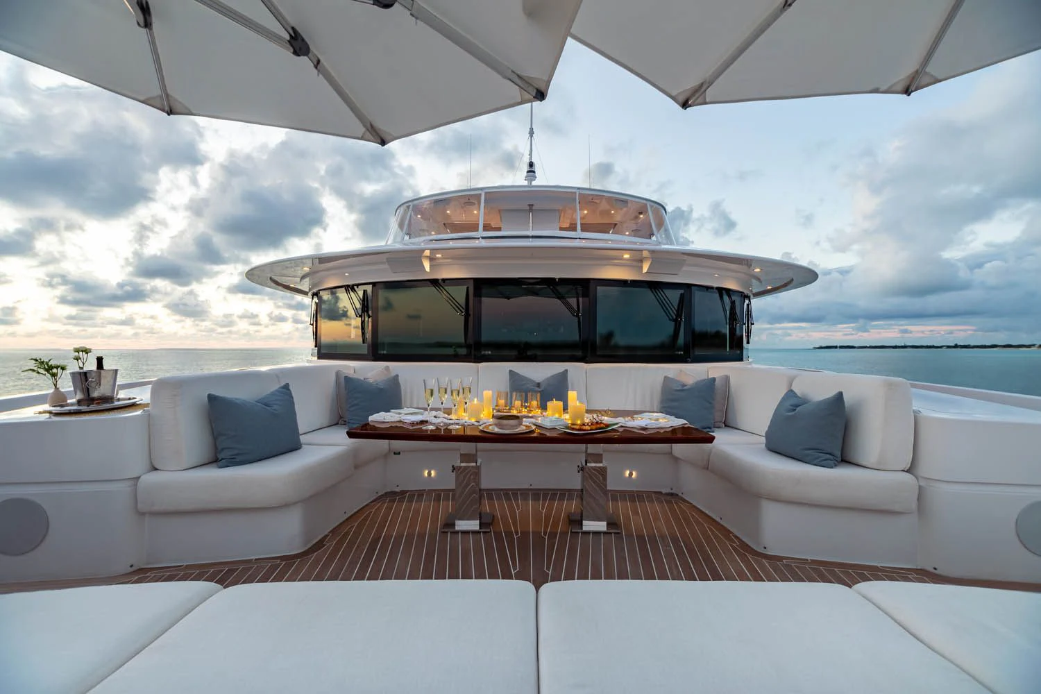 a white couch and a table on a boat in the water aboard KING BABY Yacht for Sale