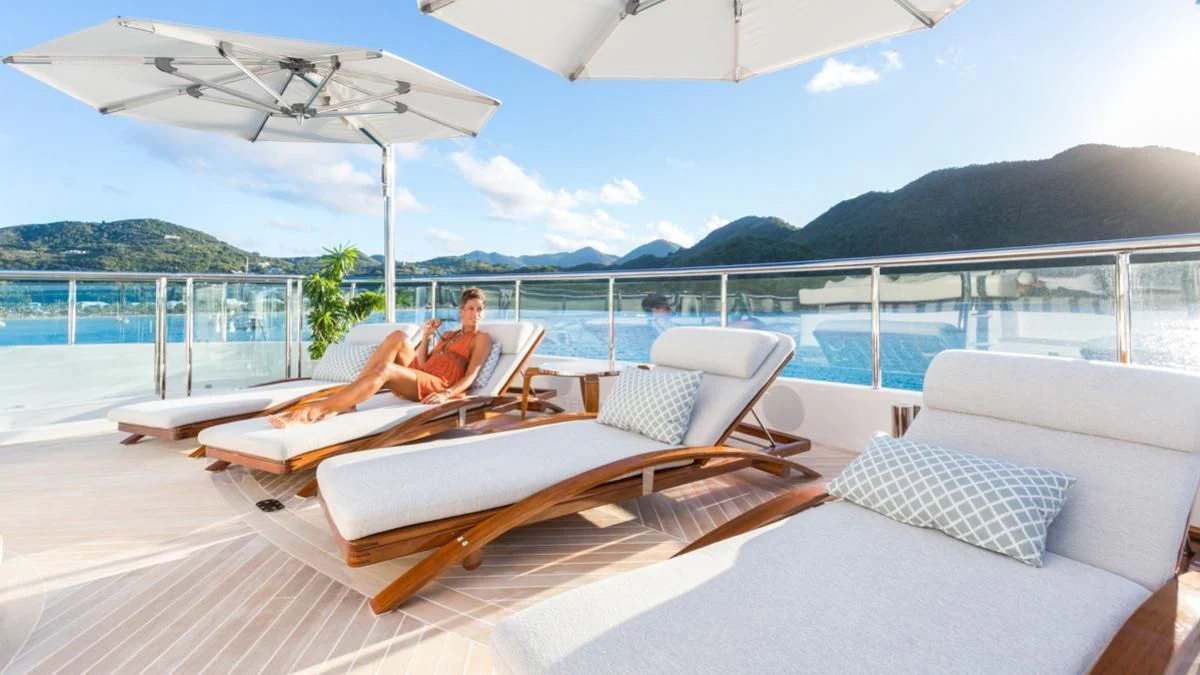 a person sitting on a lounge chair on a boat aboard KING BABY Yacht for Sale