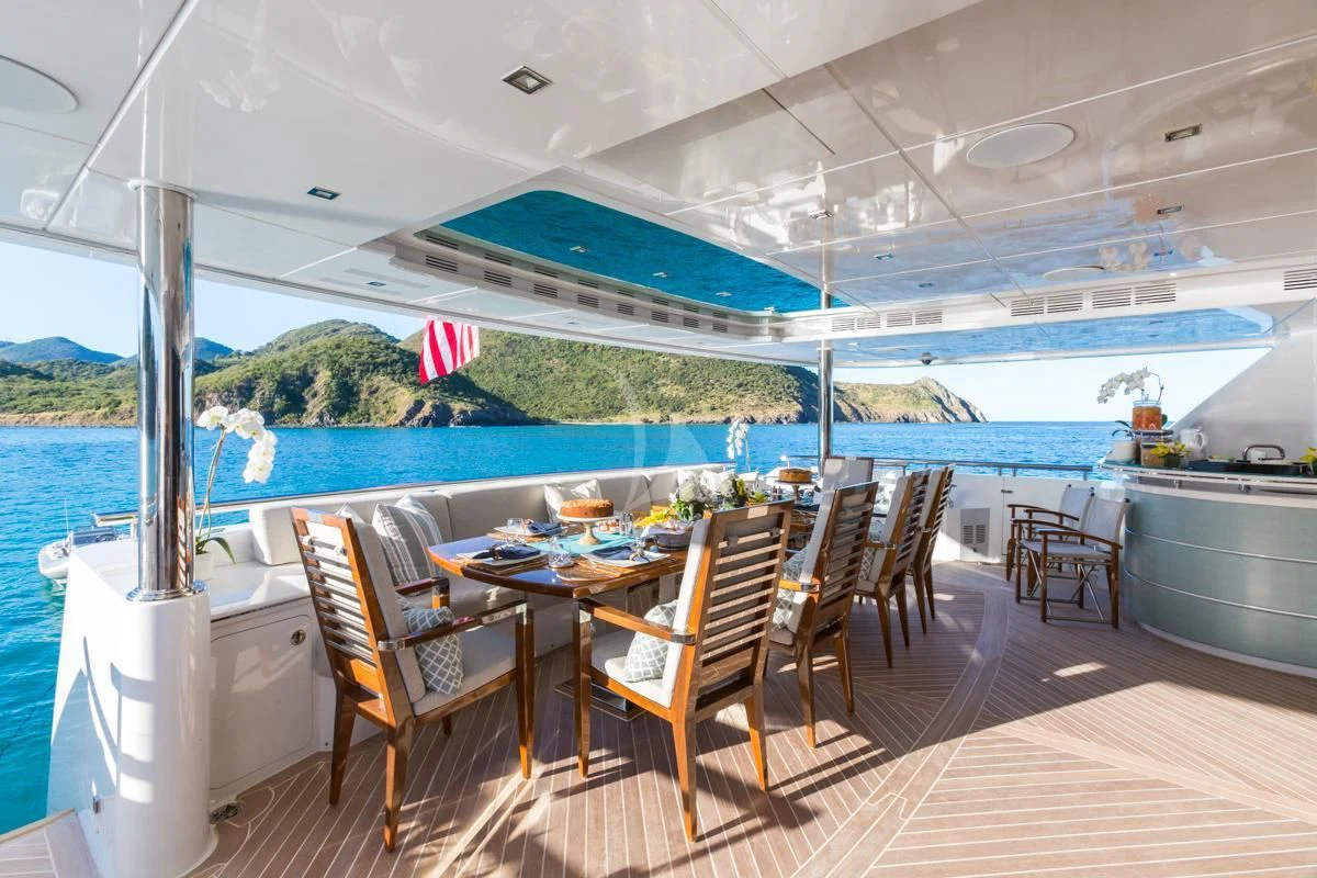 a room with a table chairs and a view of the ocean aboard KING BABY Yacht for Sale