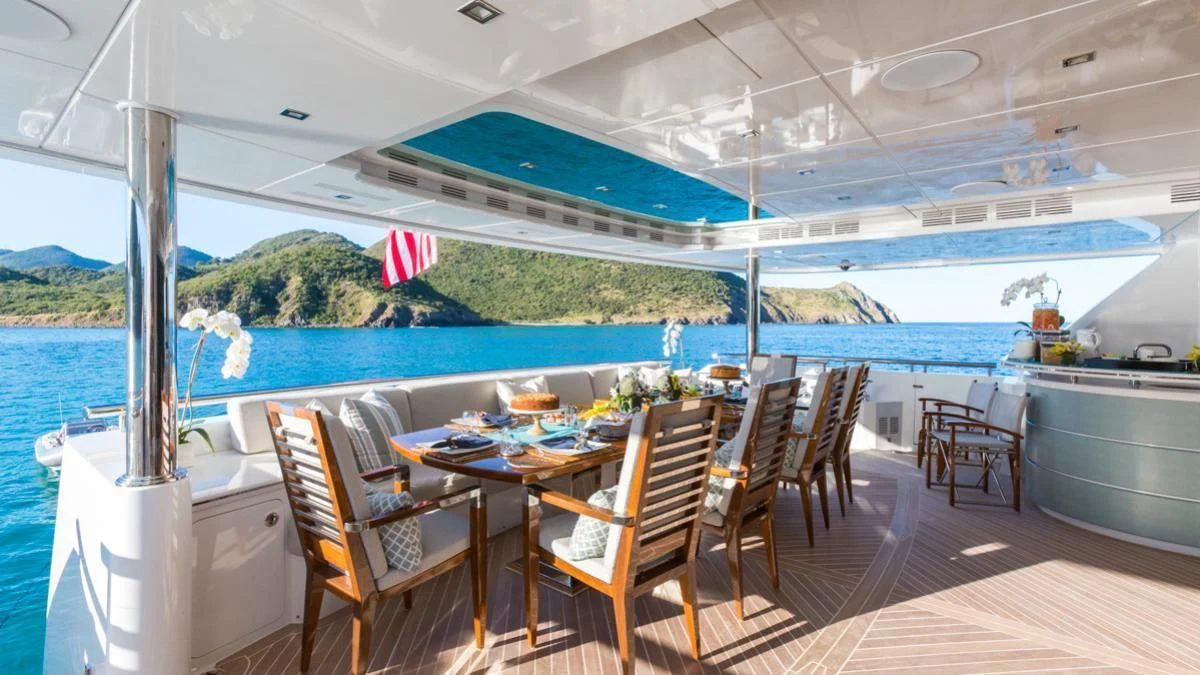 a table set for a meal on a deck aboard KING BABY Yacht for Sale