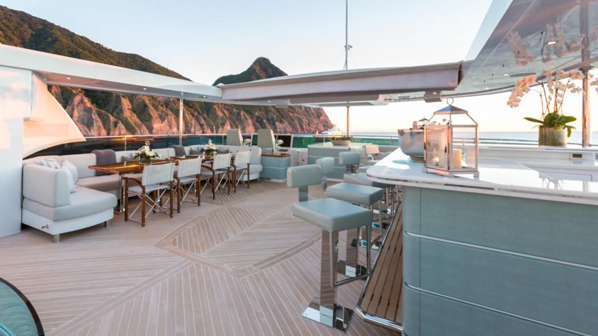 a room with a deck and chairs aboard KING BABY Yacht for Sale