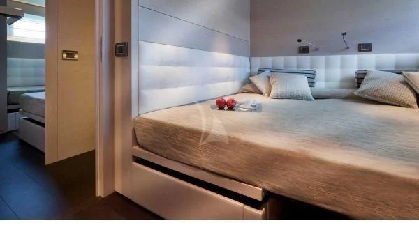 a bed with a white sheet aboard AURORA Yacht for Sale