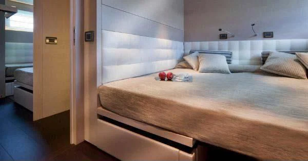 a bed with a white sheet aboard AURORA Yacht for Sale