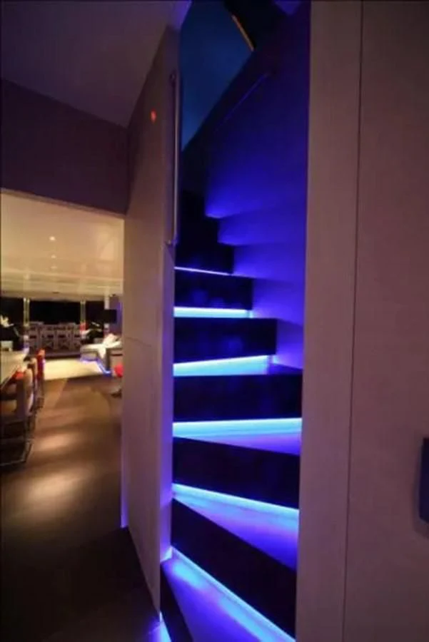 a room with a blue staircase aboard AURORA Yacht for Sale