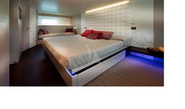 a room with a bed and a red pillow aboard AURORA Yacht for Sale