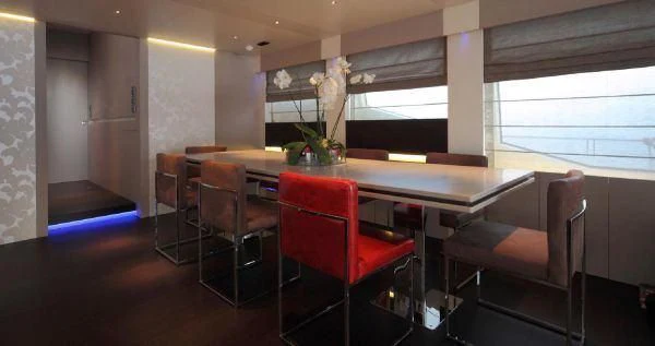 a room with a table and chairs aboard AURORA Yacht for Sale