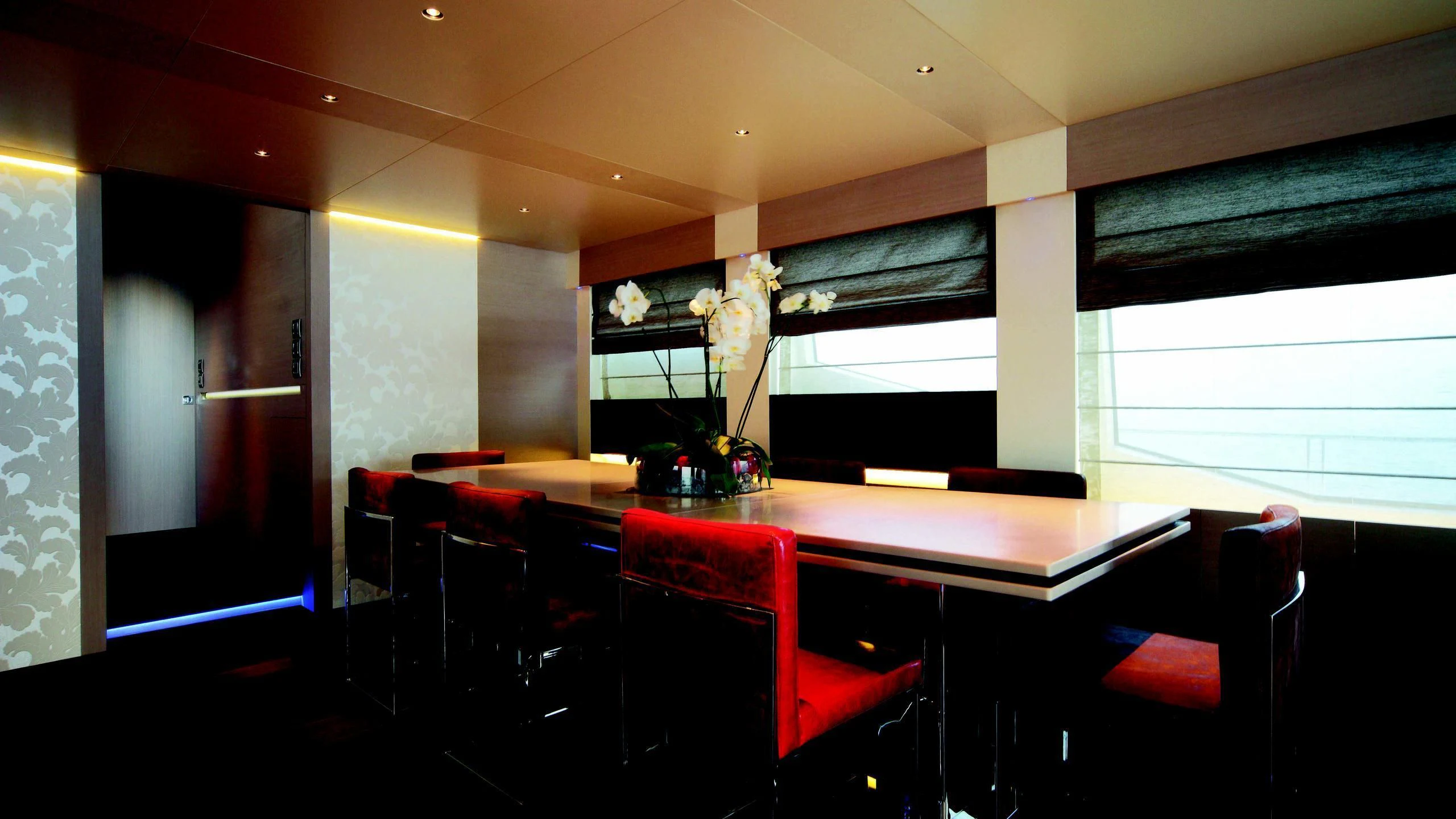 a room with a table and chairs aboard AURORA Yacht for Sale