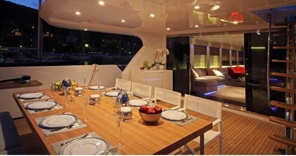 a large kitchen with a table and chairs aboard AURORA Yacht for Sale