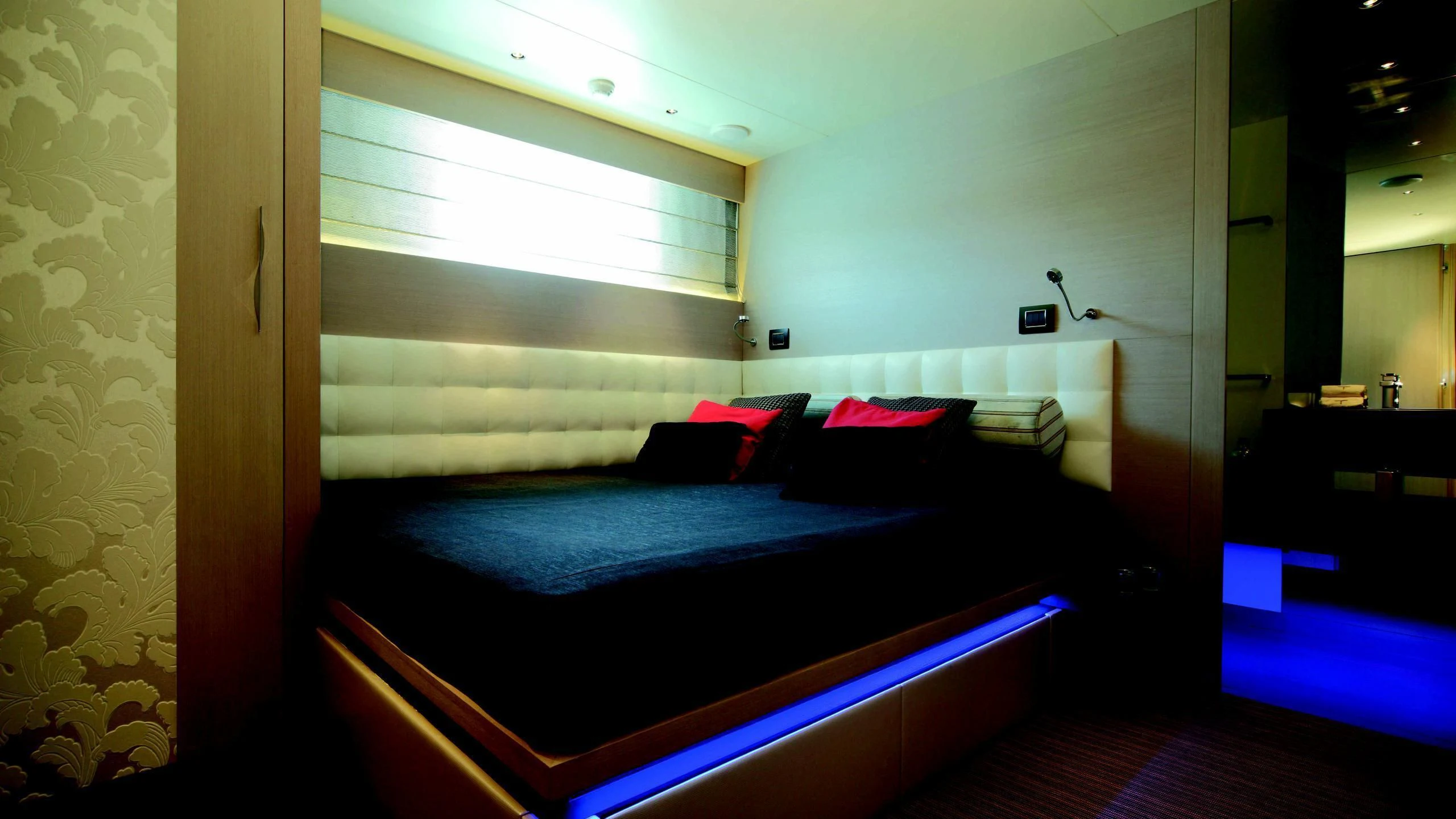 a room with a bed and a window aboard AURORA Yacht for Sale