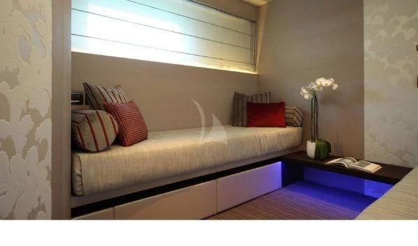 a bed with a white bed spread aboard AURORA Yacht for Sale