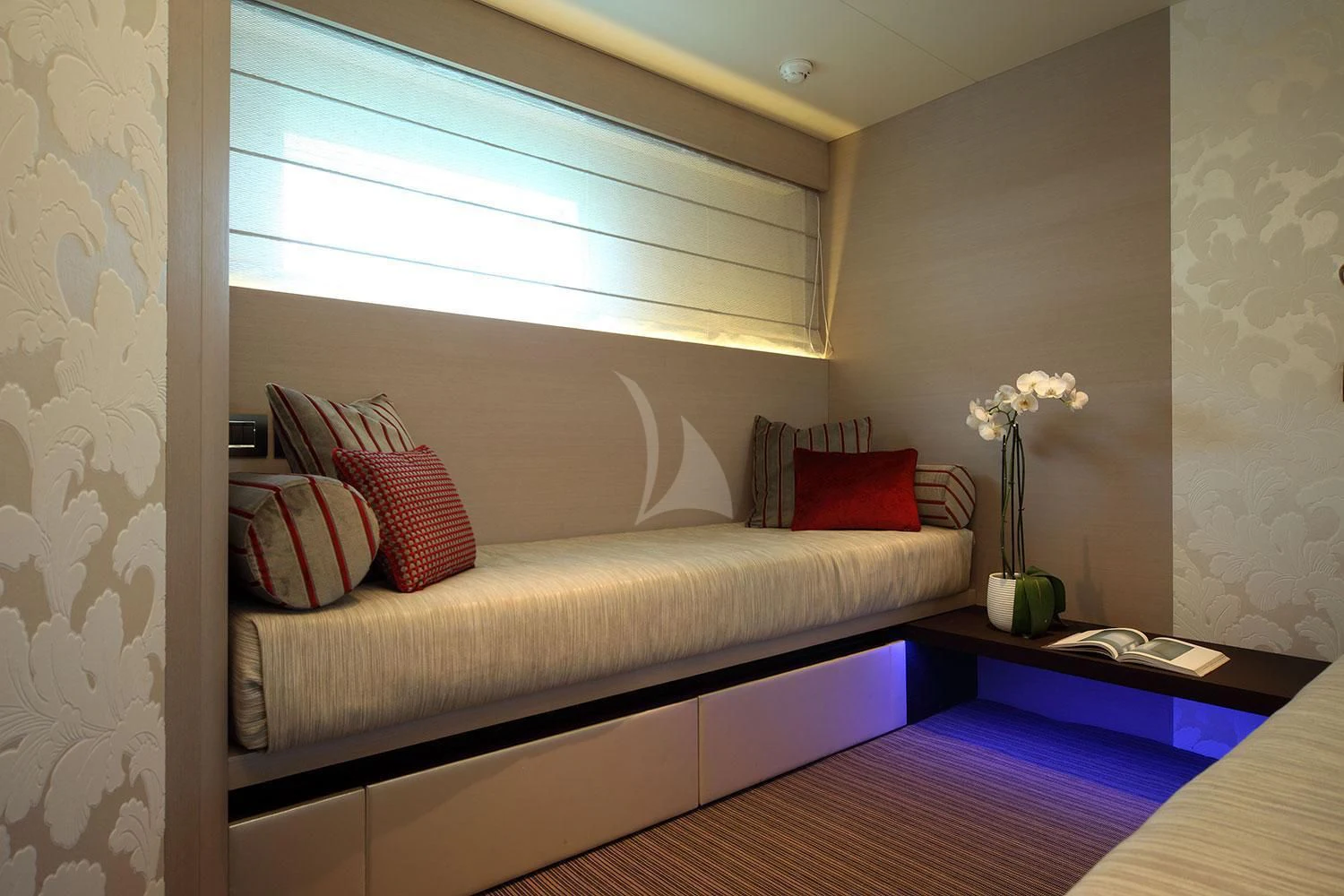 a bed with a white couch aboard AURORA Yacht for Sale