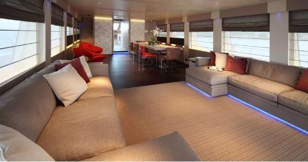a living room with a couch and a table aboard AURORA Yacht for Sale
