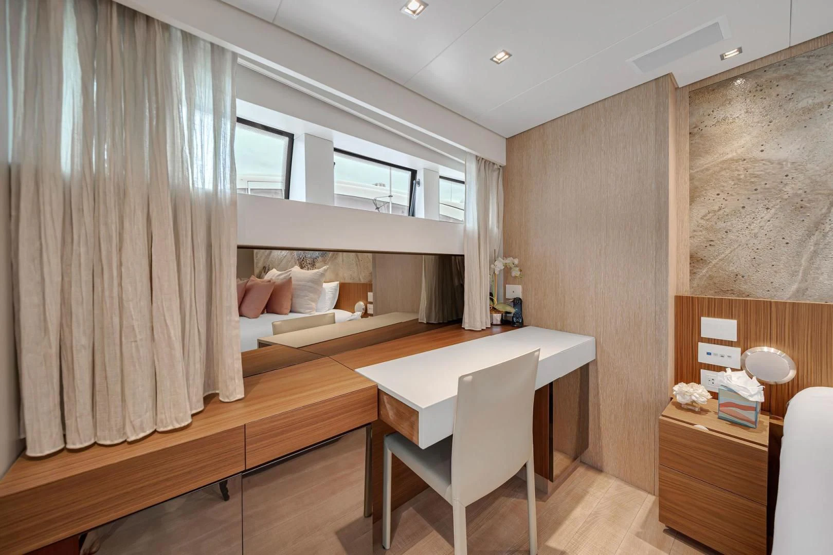 a room with a bed and desk aboard PEACEKEEPER Yacht for Sale