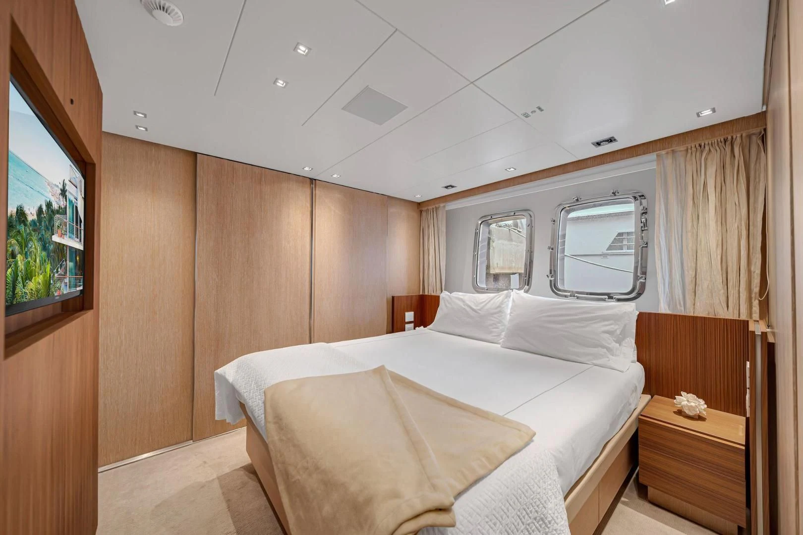 a room with a bed and a mirror aboard PEACEKEEPER Yacht for Sale