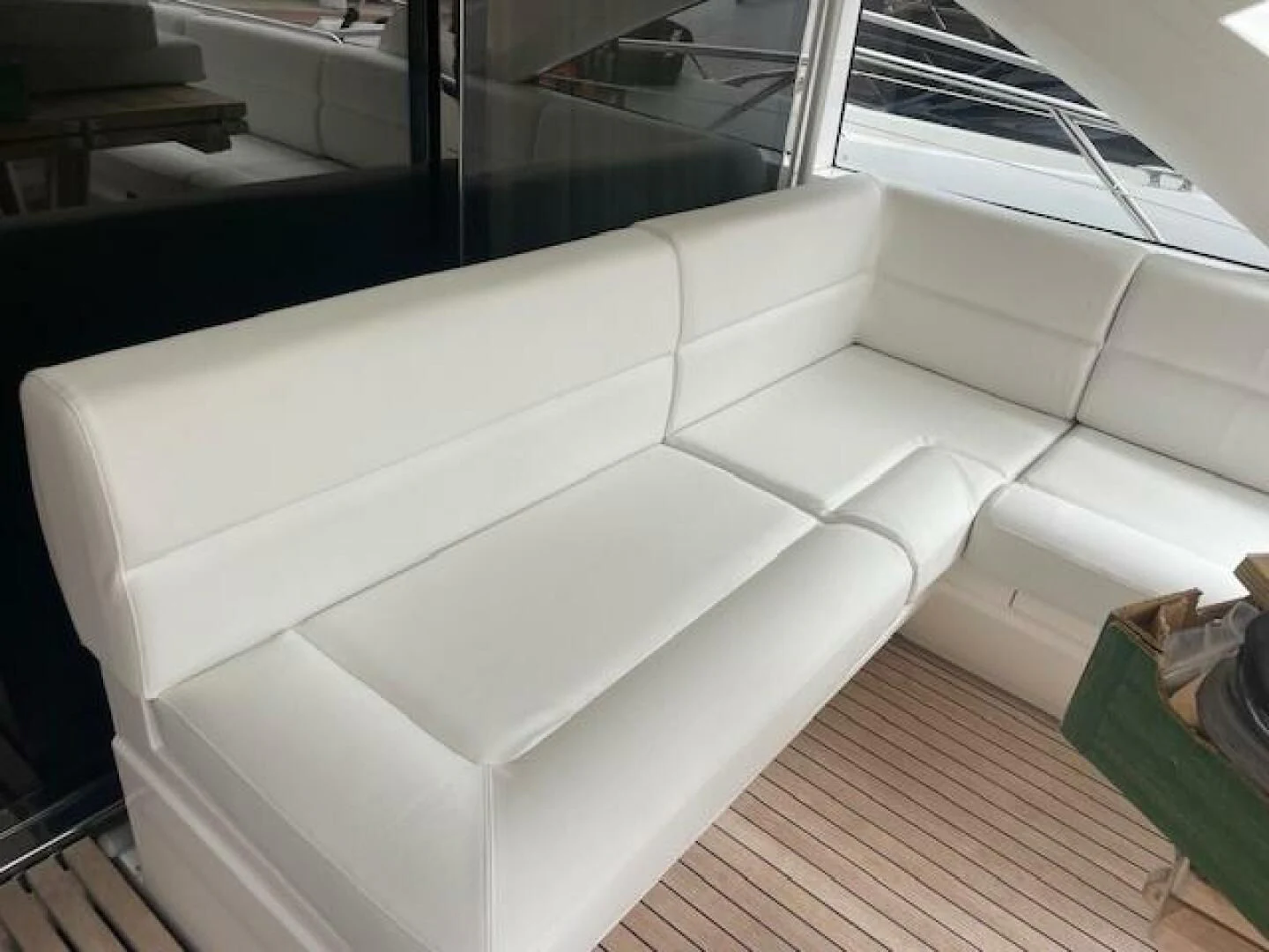 a white couch in a room aboard LONG WAY ROUND Yacht for Sale
