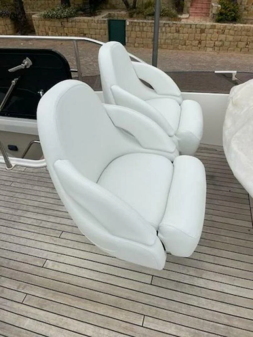 a white plastic chair aboard LONG WAY ROUND Yacht for Sale