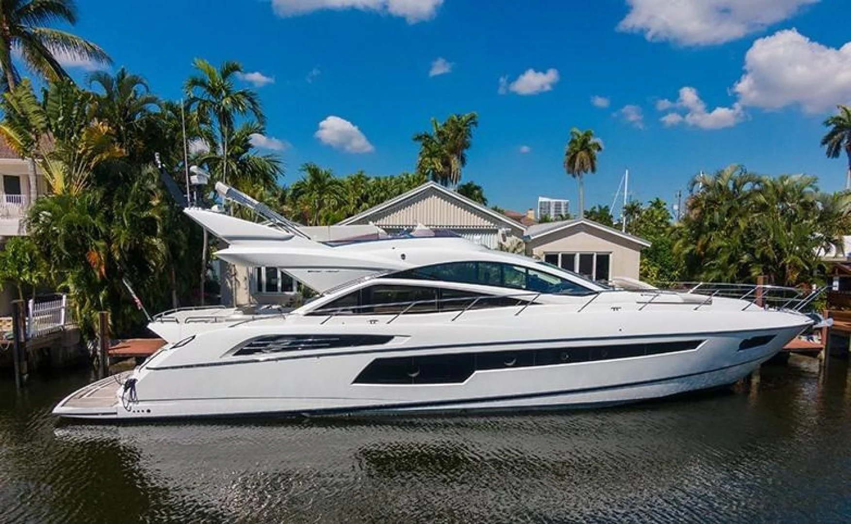 a white yacht on a dock aboard LONG WAY ROUND Yacht for Sale
