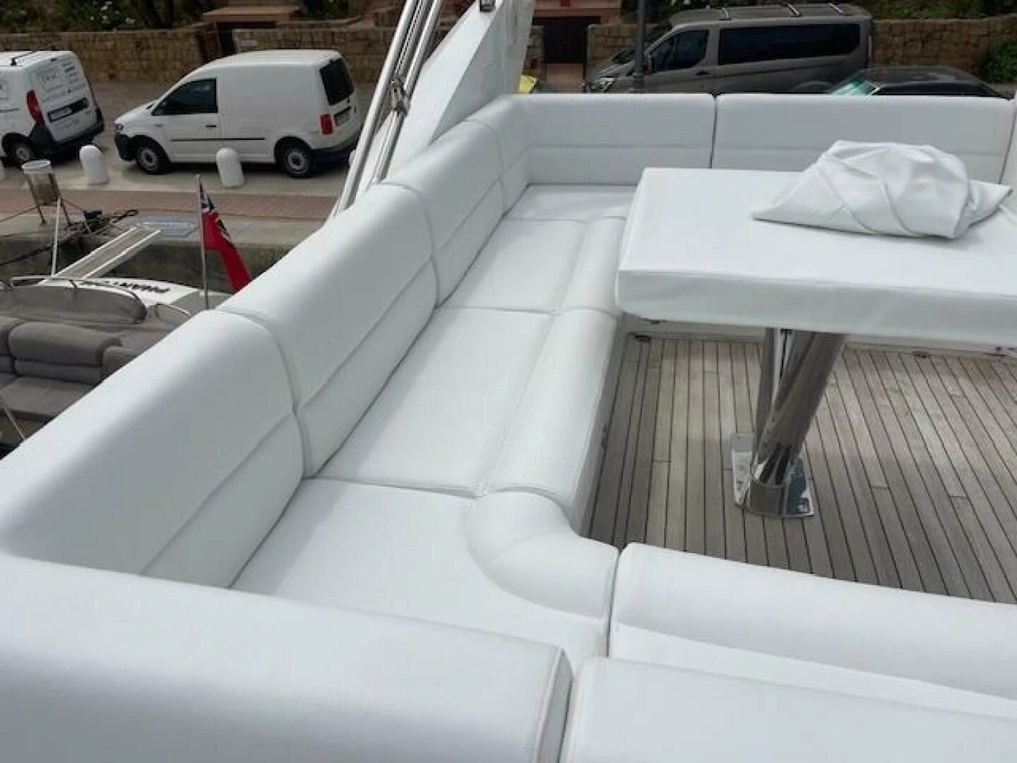 a white couch with a white table and chairs on it aboard LONG WAY ROUND Yacht for Sale