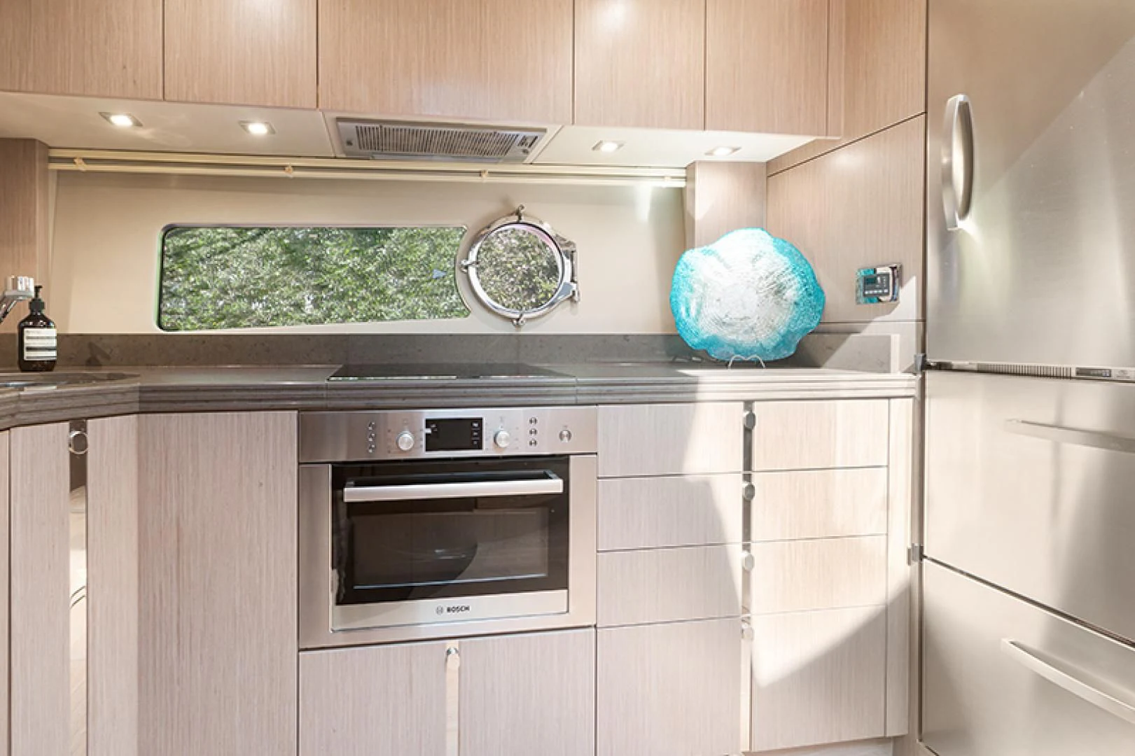 a kitchen with a microwave oven and cabinets aboard LONG WAY ROUND Yacht for Sale