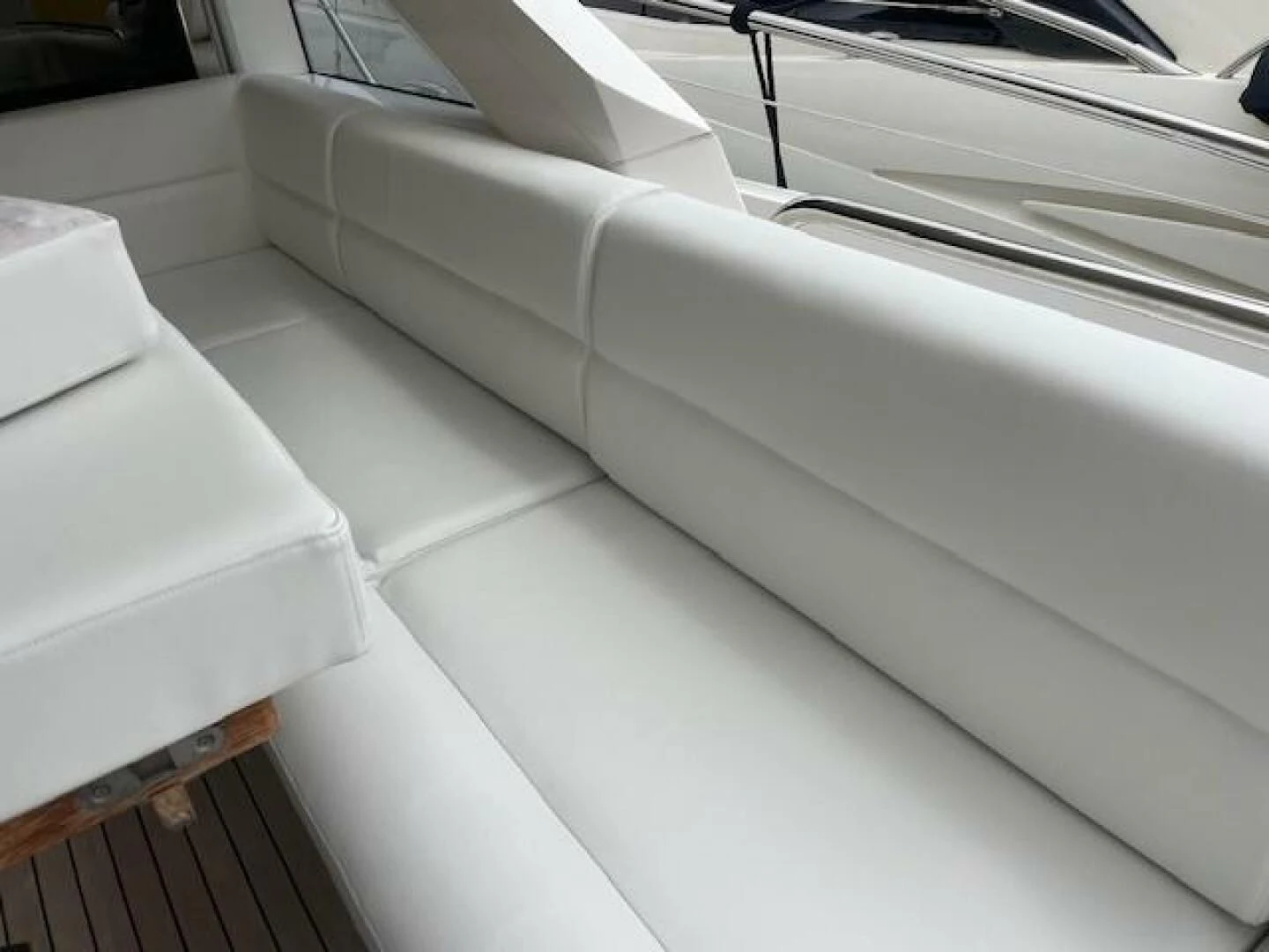 a white couch in a room aboard LONG WAY ROUND Yacht for Sale