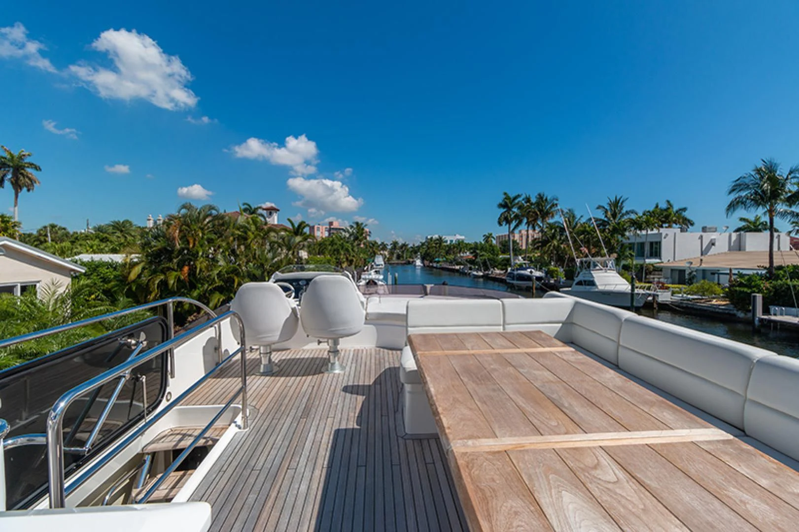 a deck with a deck and trees aboard LONG WAY ROUND Yacht for Sale