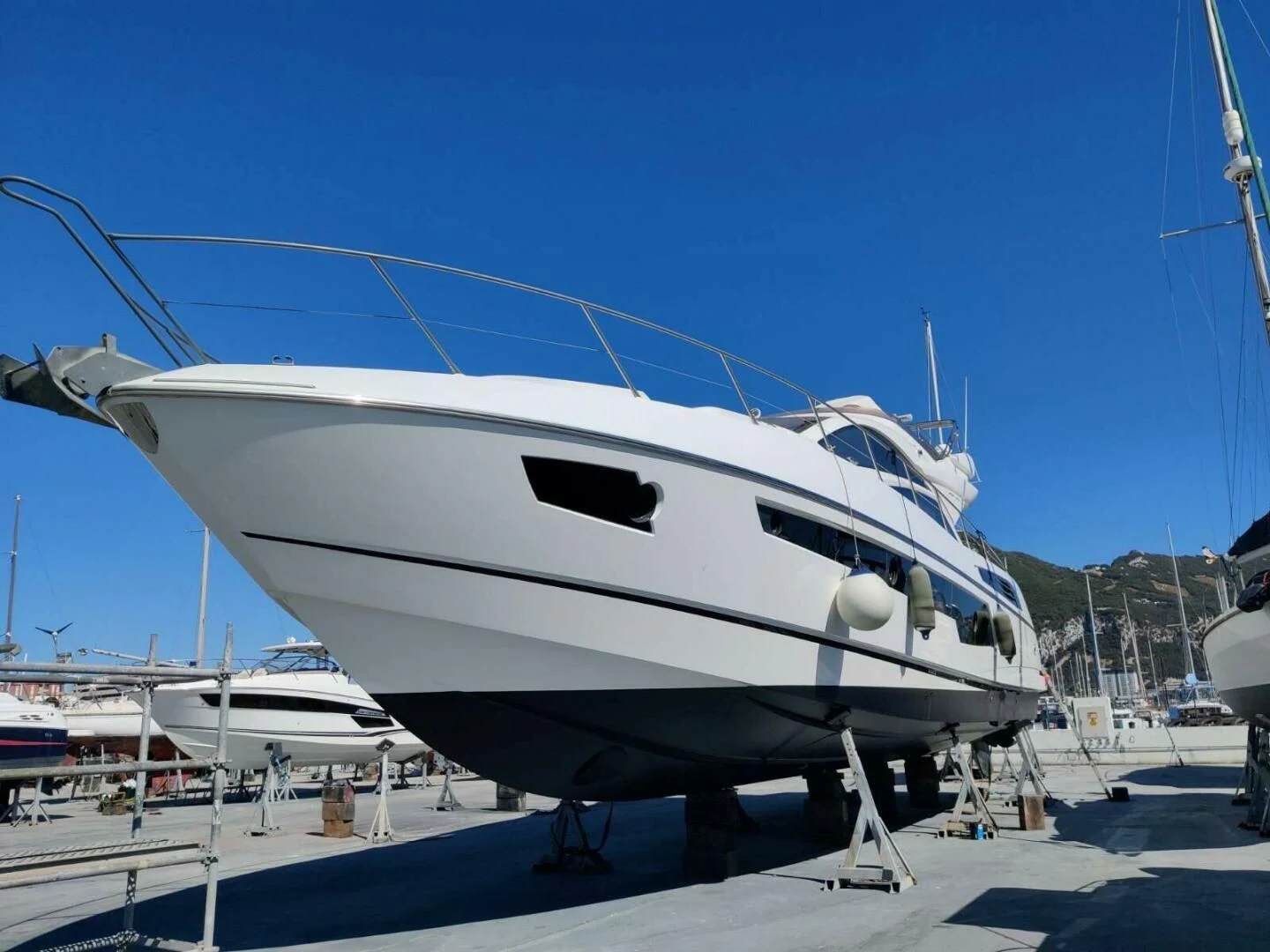 a white yacht on a dock aboard LONG WAY ROUND Yacht for Sale