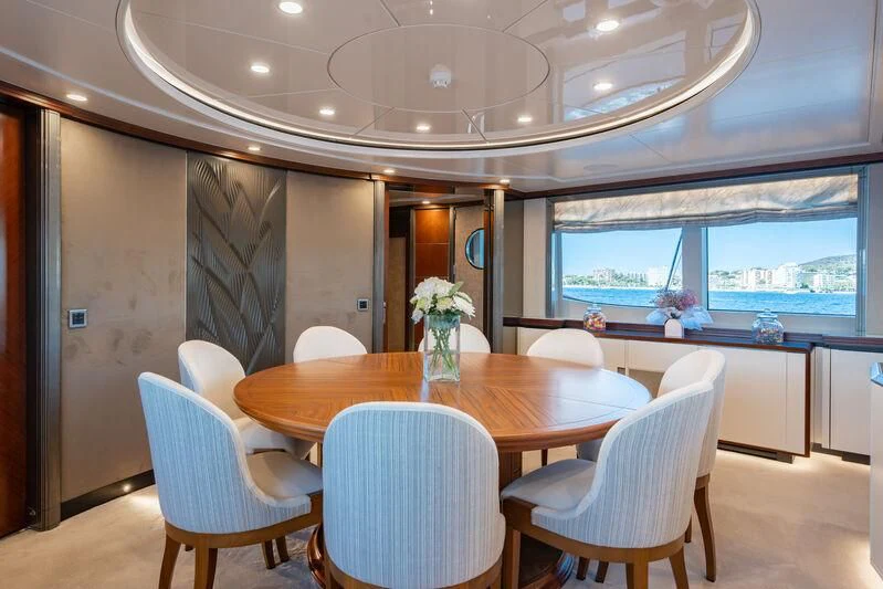 a dining room with a table and chairs aboard TITIAN PEARL Yacht for Sale