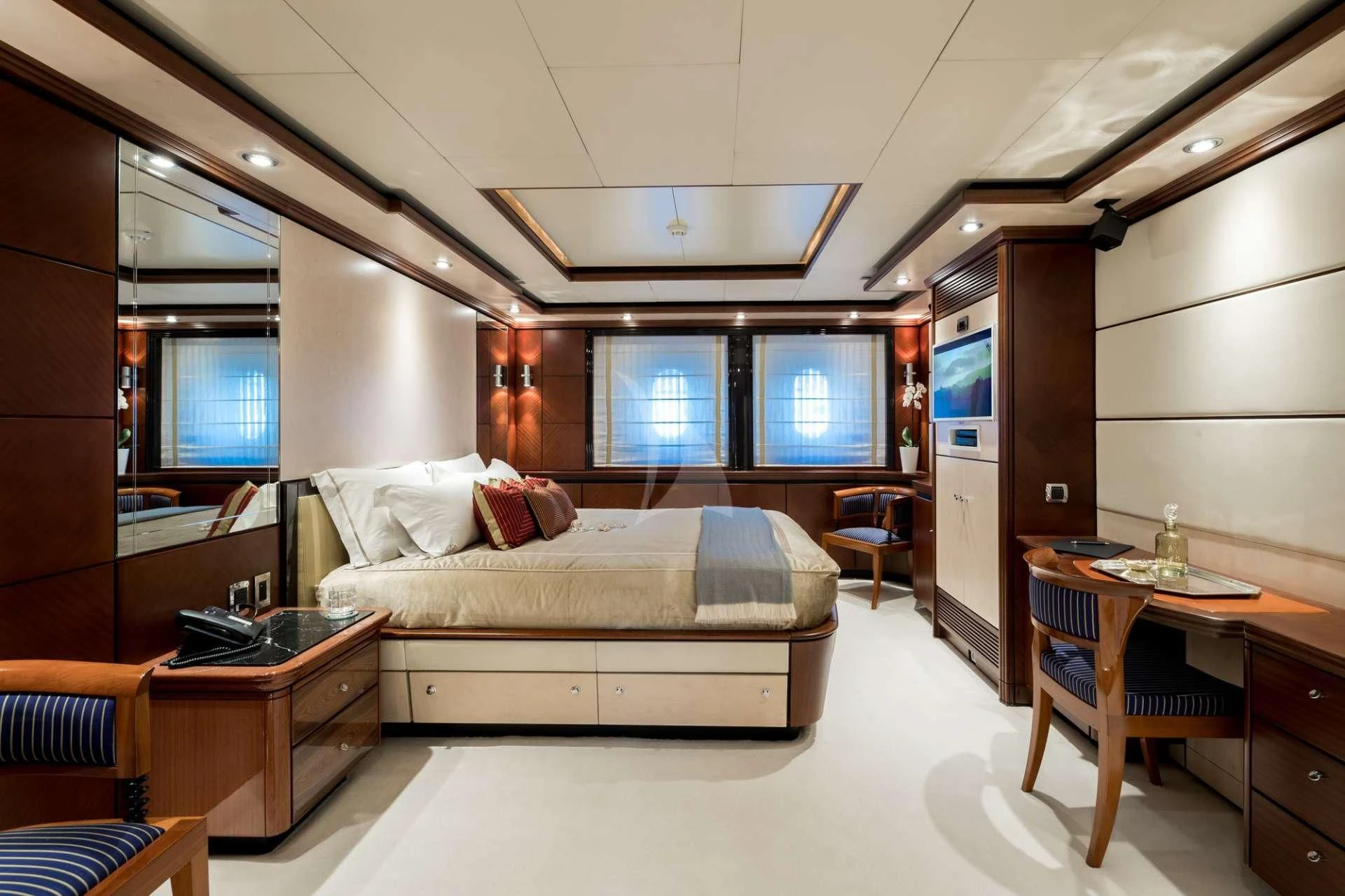 a bedroom with a bed and desk aboard TITIAN PEARL Yacht for Sale