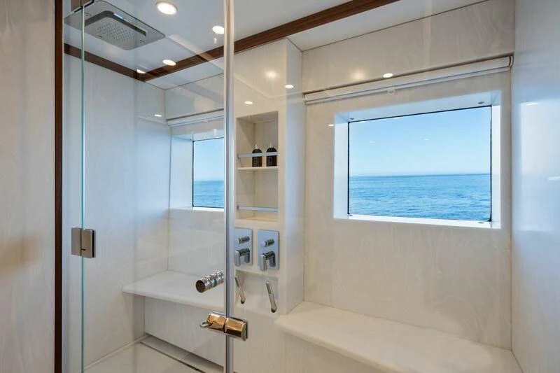 a bathroom with a glass shower aboard TITIAN PEARL Yacht for Sale