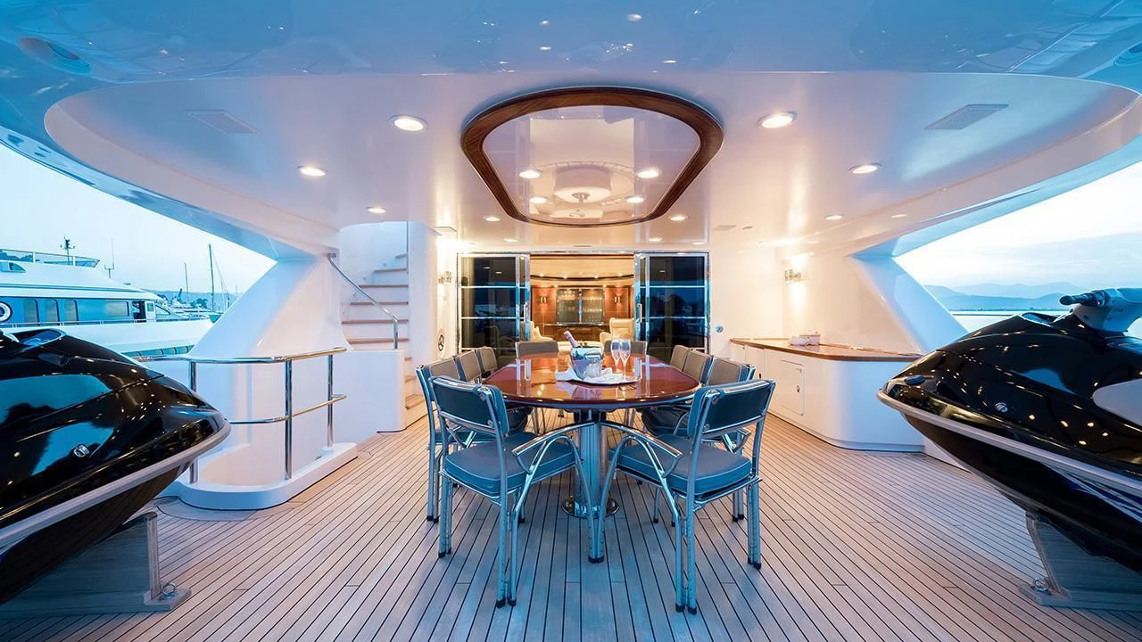 a dining room with a table and chairs aboard TITIAN PEARL Yacht for Sale