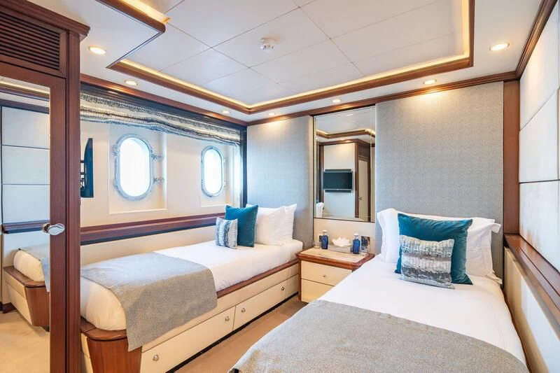 a couple of beds in a hotel room aboard TITIAN PEARL Yacht for Sale