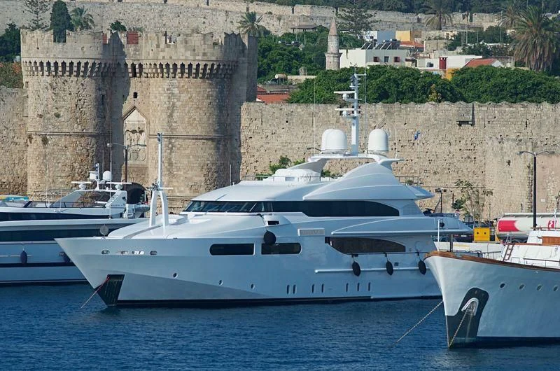 a group of boats sit in a harbor aboard TITIAN PEARL Yacht for Sale