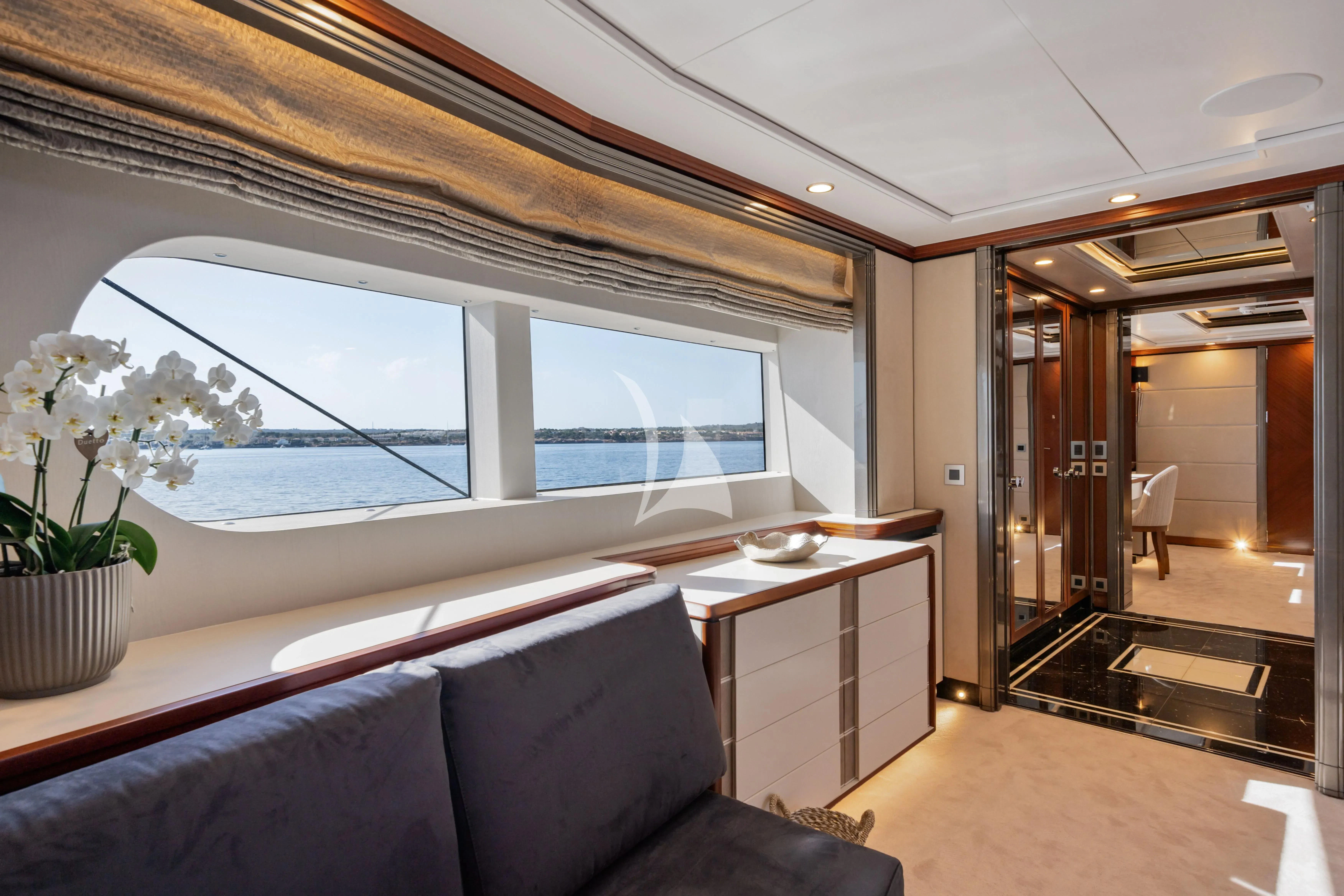 a room with a large window and a view of the water aboard TITIAN PEARL Yacht for Sale