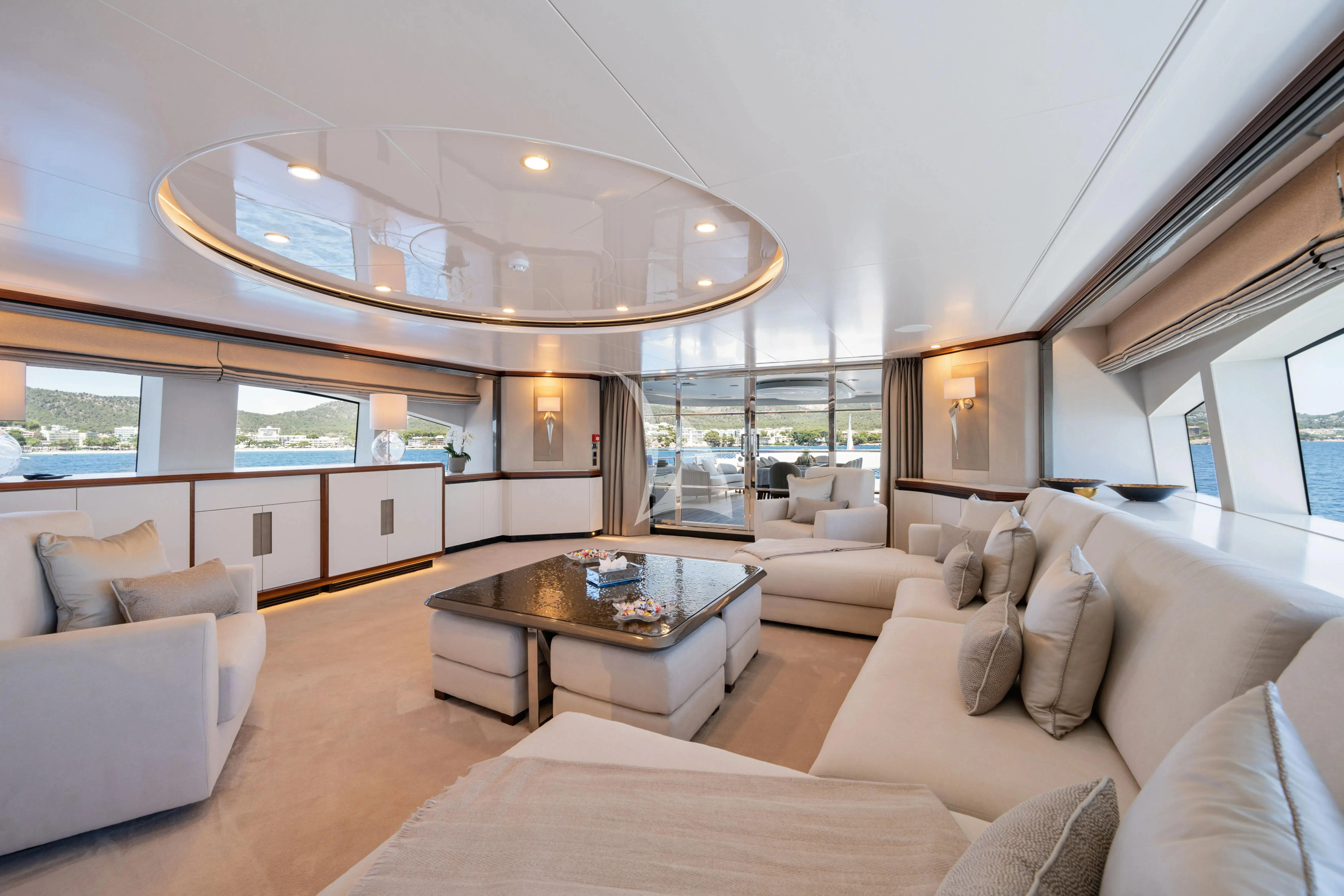a living room with a large chandelier aboard TITIAN PEARL Yacht for Sale
