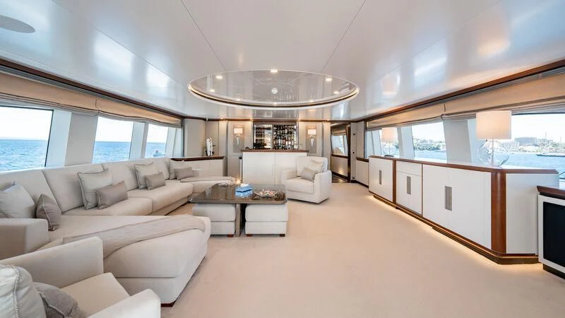a large living room with a large chandelier aboard TITIAN PEARL Yacht for Sale