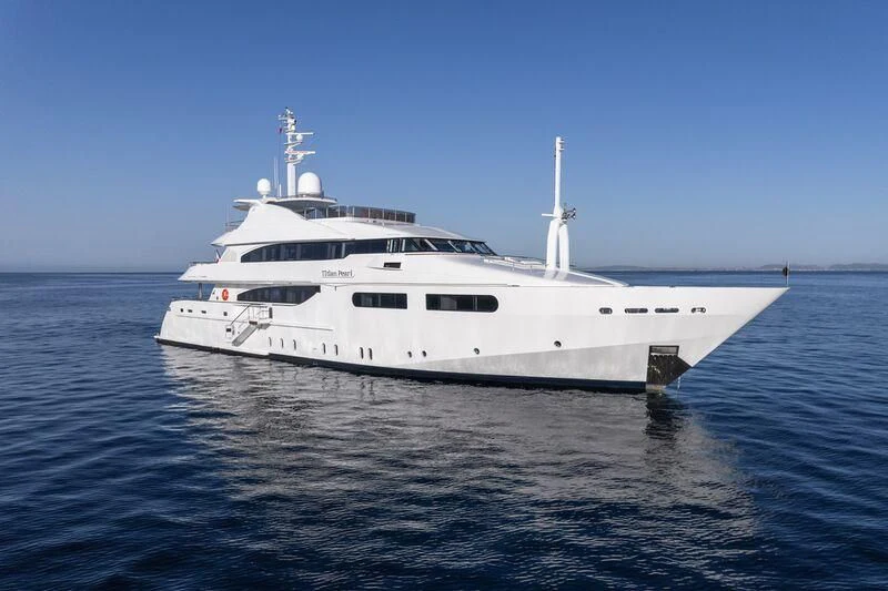 a white yacht in the water aboard TITIAN PEARL Yacht for Sale