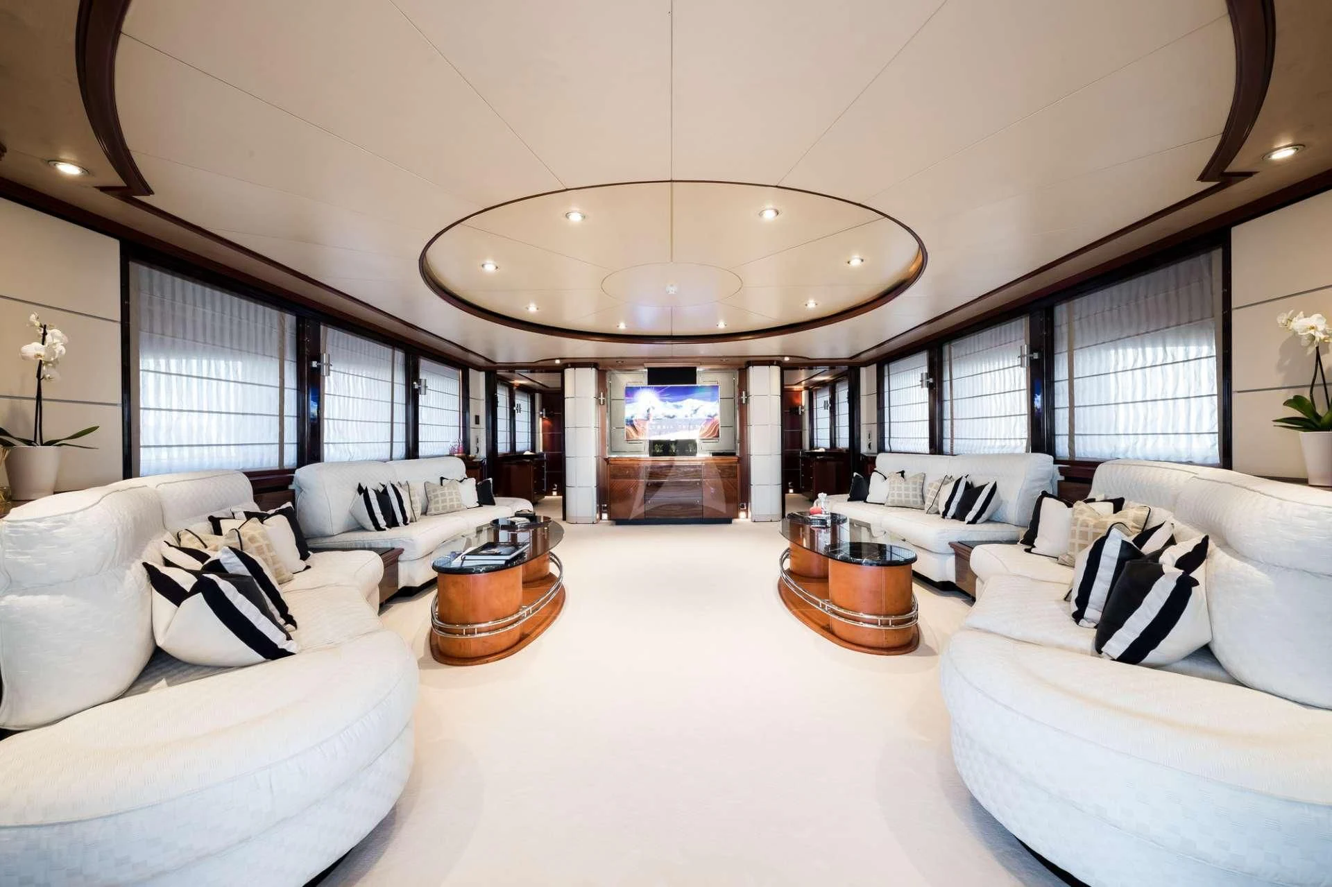 a large living room with white furniture aboard TITIAN PEARL Yacht for Sale