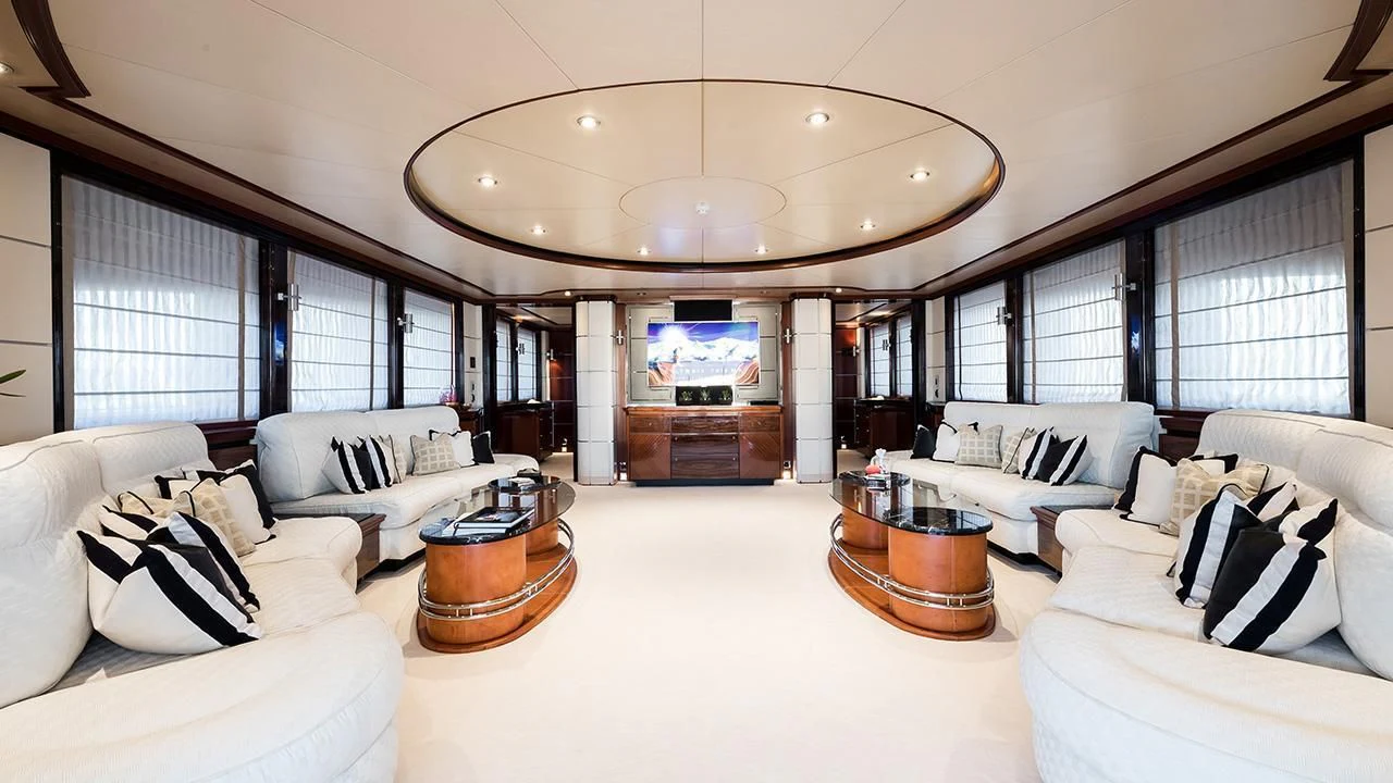 a large living room with white furniture aboard TITIAN PEARL Yacht for Sale