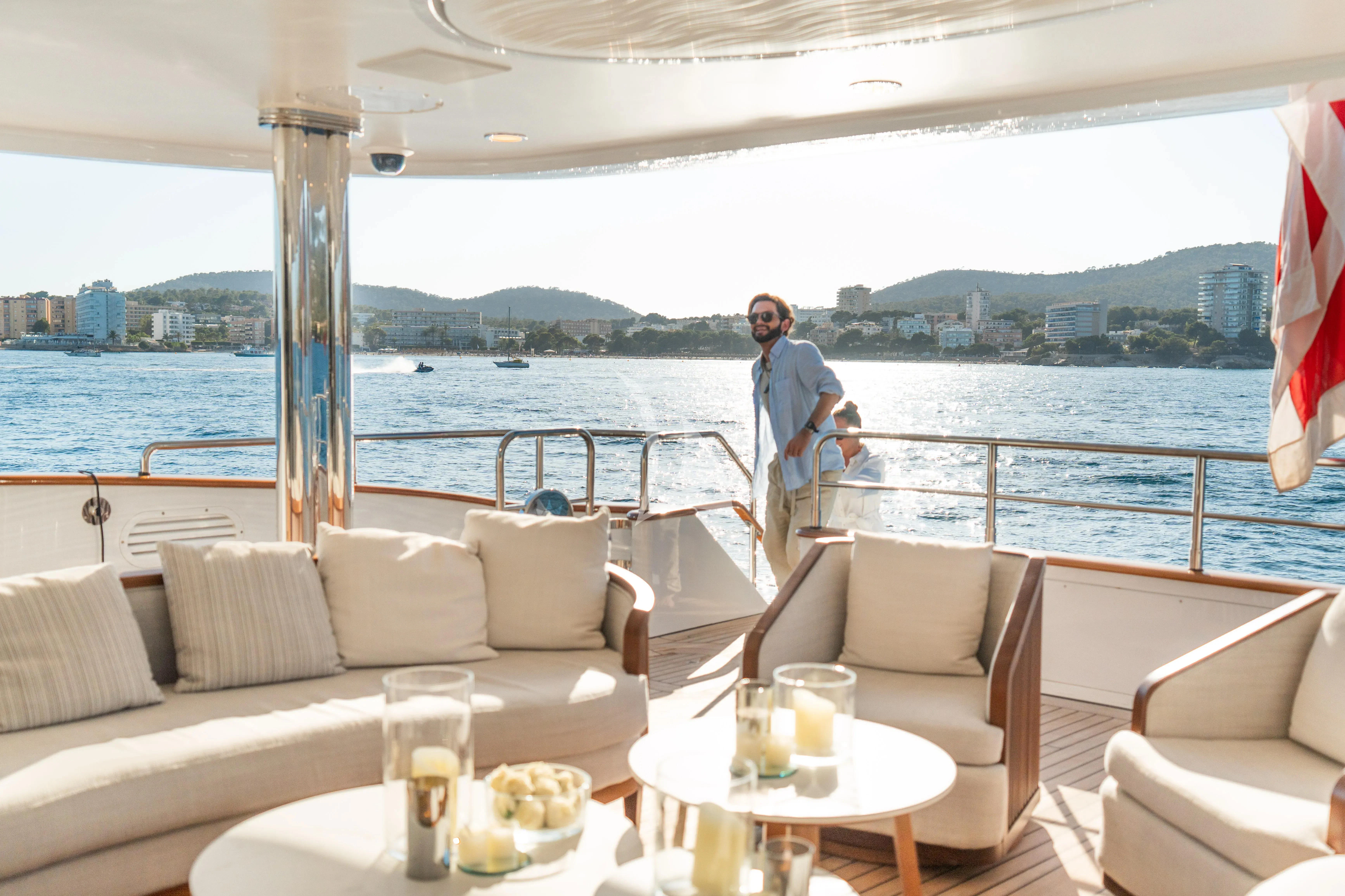 a person standing on a balcony overlooking a body of water aboard TITIAN PEARL Yacht for Sale